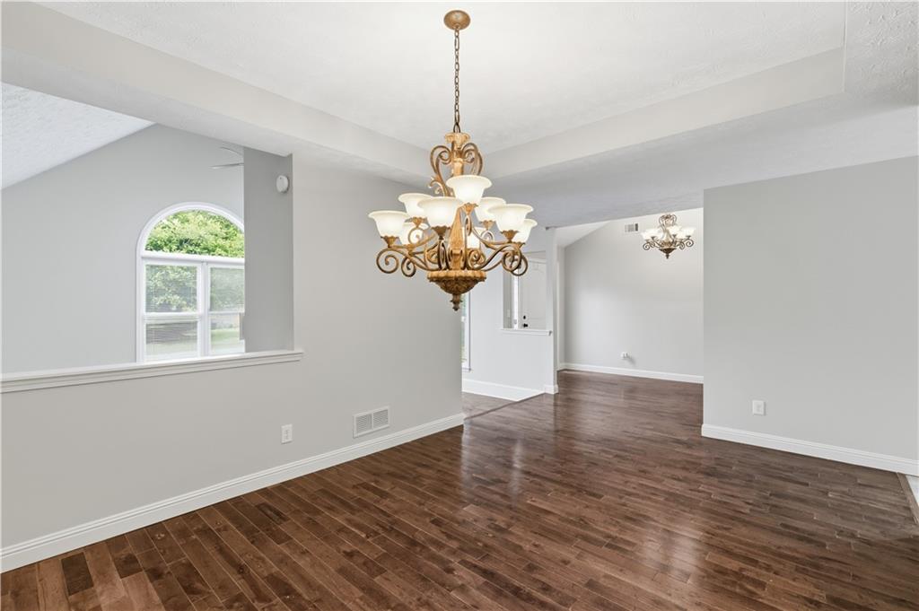 2824 Carriage Rowe Duluth, GA 30096 - Photo 9 of 45 a view of a room with wooden floor and chandelier