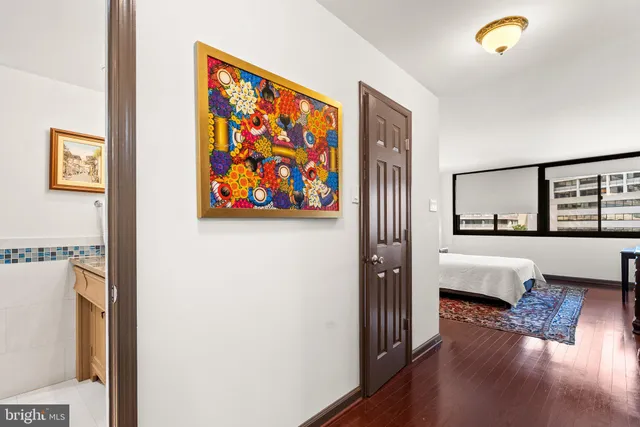 a bedroom with furniture and wooden floor