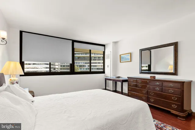 a living room with a bed furniture and a large window