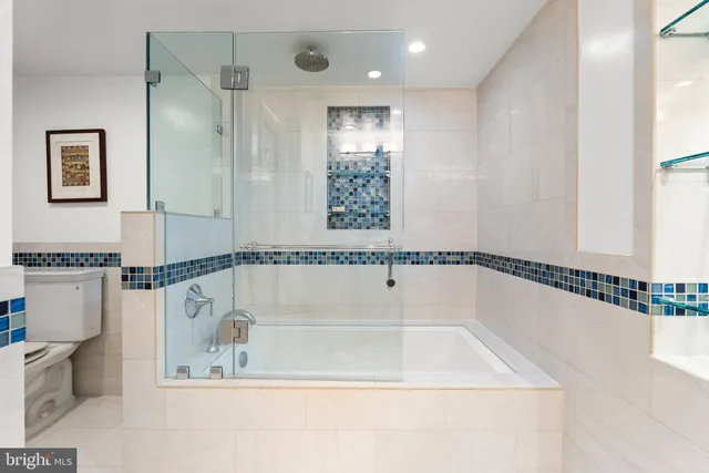 a bathroom with a bathtub and a shower