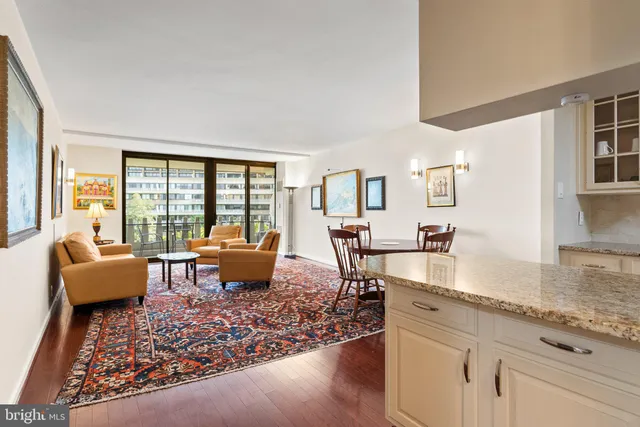 a living room with furniture and large windows