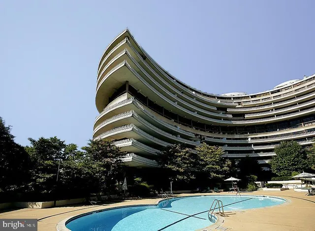 a living room with furniture chandelier and a large window