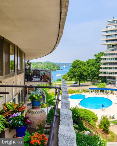 a view of a swimming pool with a patio and a garden