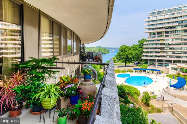 a view of a swimming pool with outdoor seating