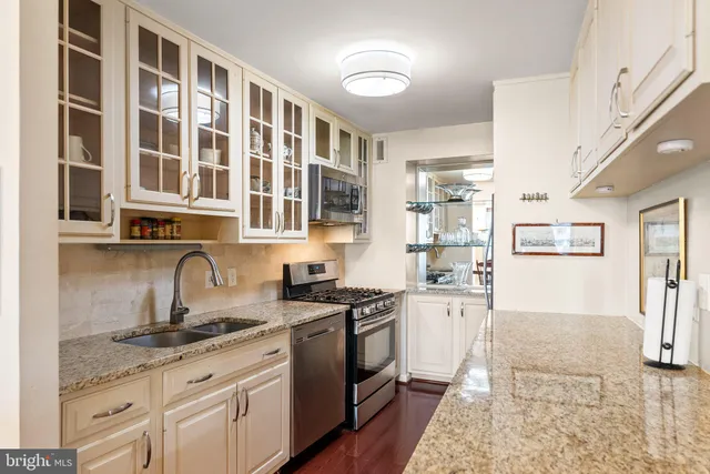 a kitchen with stainless steel appliances granite countertop a sink and cabinets