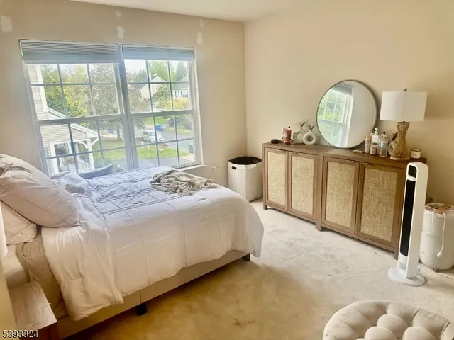 a bed sitting in a bedroom next to a window