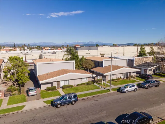 a view of a patio with table and chairs potted plants