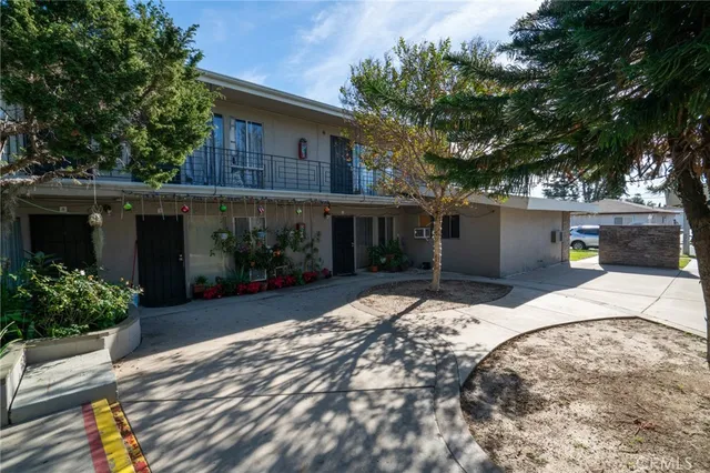 a front view of a house with a yard and a garden