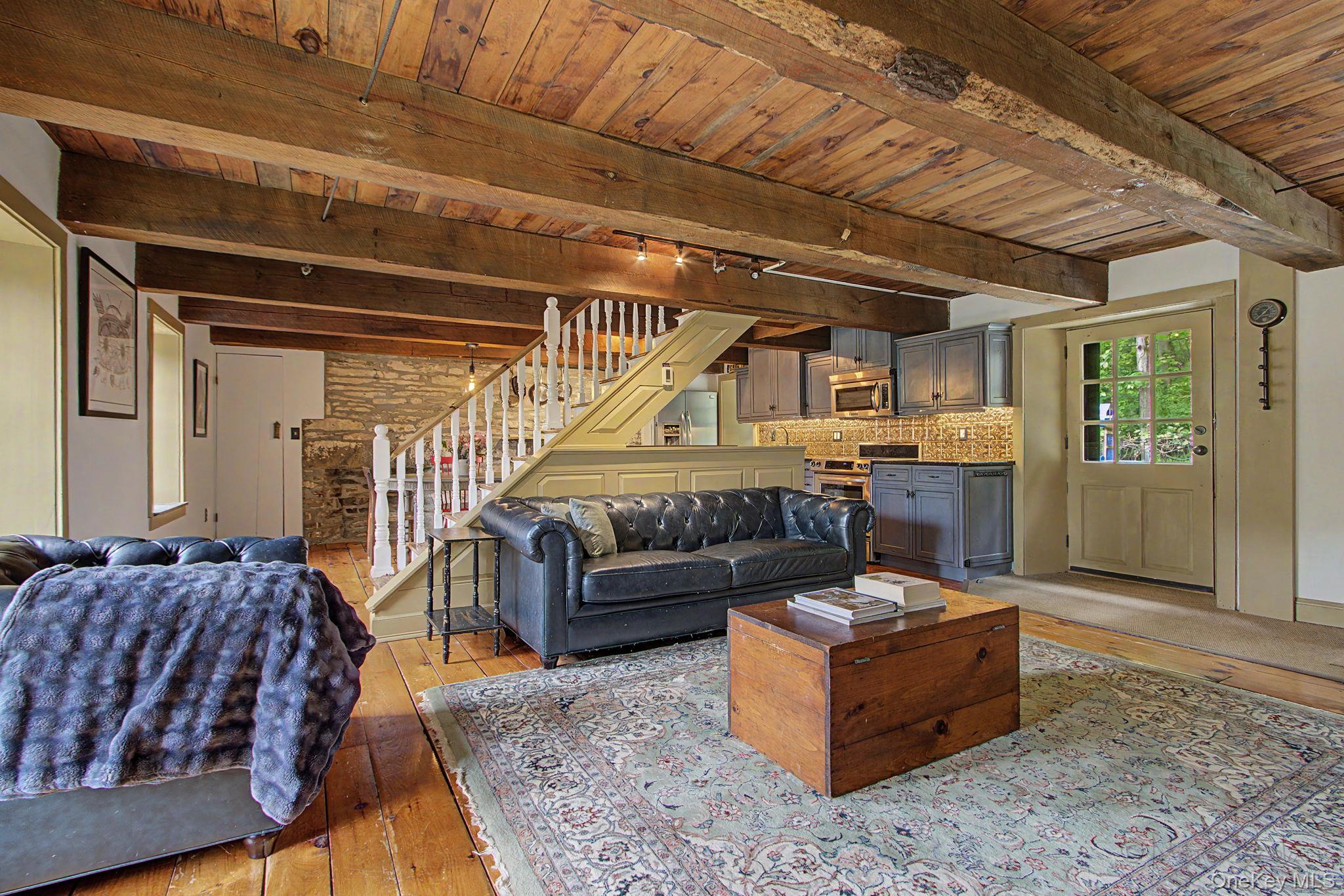 168 Old Rte 55 Pawling, NY 12564 - Photo 7 of 43 a living room with couch and a dining table with wooden floor