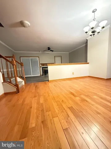 a view of a room with wooden floor