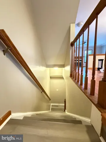 a view of staircase with lots of frames on wall