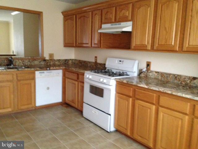 208 Rugby Road Fredericksburg, VA 22406 - Photo 3 of 4 a kitchen with stainless steel appliances granite countertop a stove a sink and a microwave