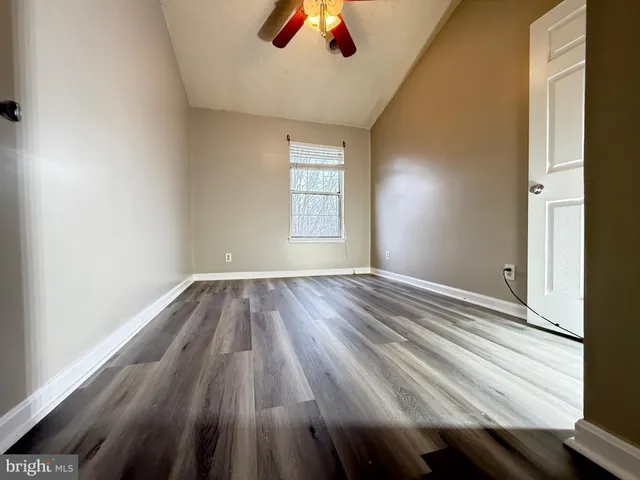 a view of room with window and wooden floor
