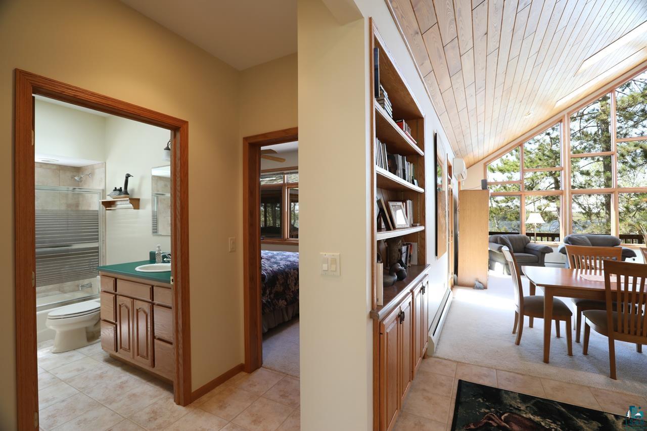 1880 Everett Bay Road Tower, MN 55790 - Photo 15 of 50 Hallway featuring light tile patterned floors, light carpet, vaulted ceiling, and wood ceiling