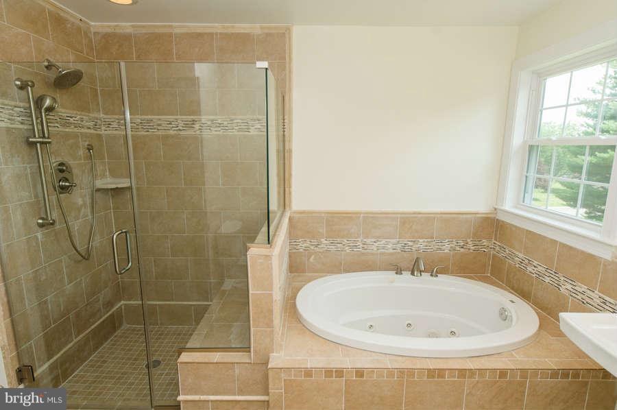 13029 Fork Road Baldwin, MD 21013 - Photo 14 of 30 a bathroom with a bathtub and shower