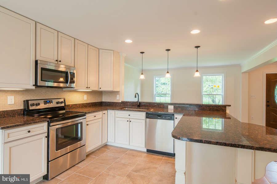 13029 Fork Road Baldwin, MD 21013 - Photo 8 of 30 a kitchen with stainless steel appliances granite countertop a stove a sink and a microwave