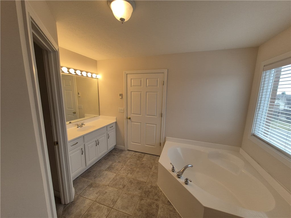 633 Orient Way Hamilton, OH 45013 - Photo 53 of 68 This bathroom features a soaking tub, dual vanity, and durable tile flooring for everyday convenience.
