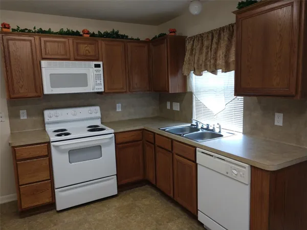a kitchen with a sink stove and microwave