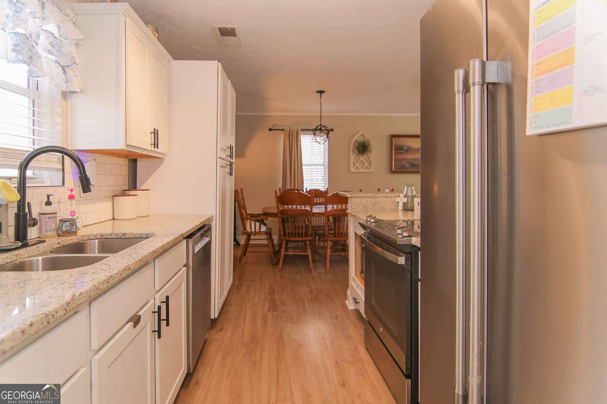 338 Young Road Franklin, GA 30217 - Photo 16 of 43 a kitchen with a sink and wooden cabinets