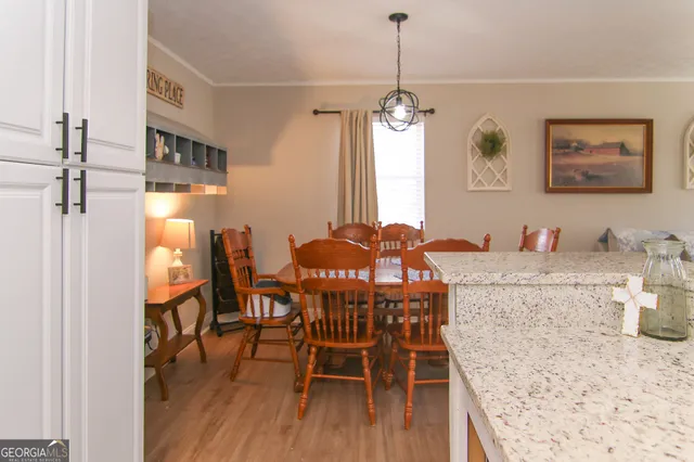 a view of a dining room with furniture window and wooden floor