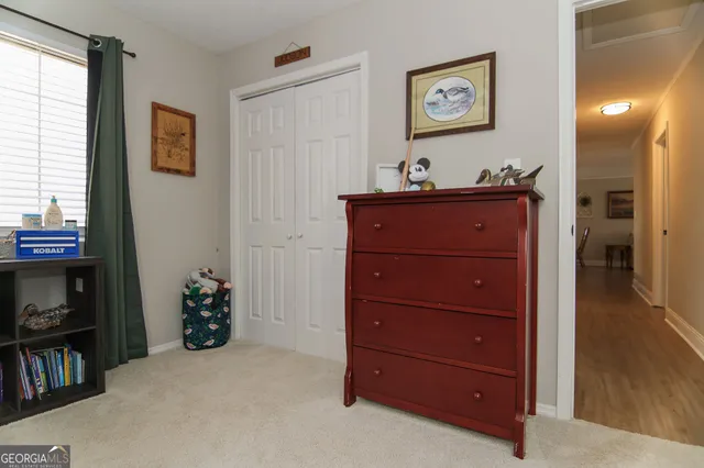 a room with a dresser and a flat screen tv