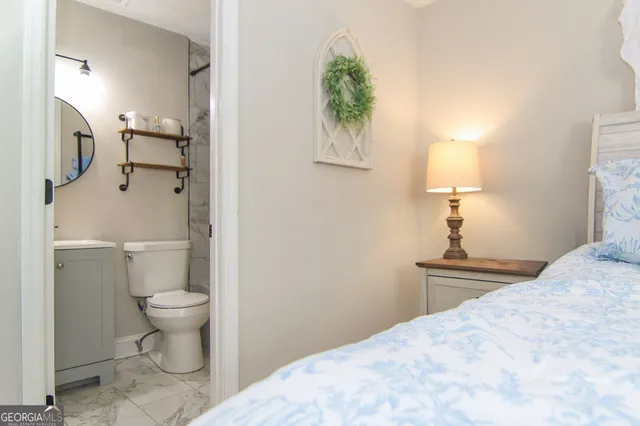 a bathroom with a toilet sink and a mirror
