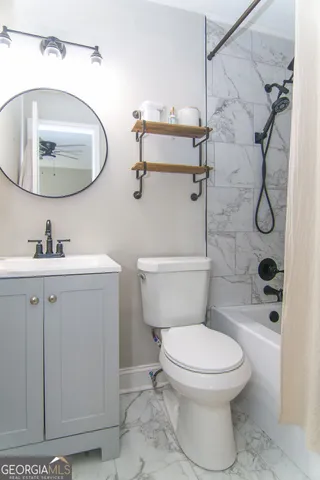 a bathroom with a toilet sink and mirror