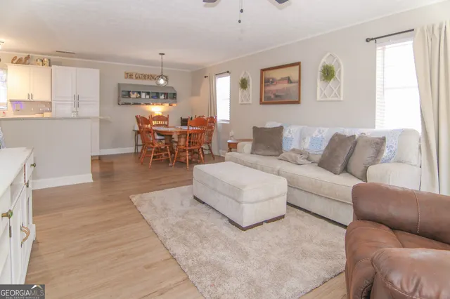 a living room with furniture and wooden floor