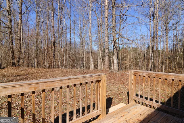 a view of wooden fence and trees
