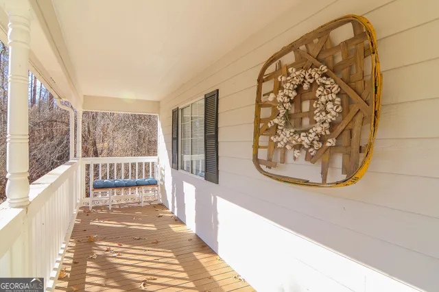 a view of a hallway with wooden floor and windows