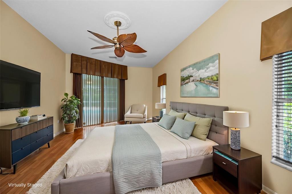 11917 Hadleigh Way Trinity, FL 34655 - Photo 25 of 84 a bedroom with a bed and a flat screen tv