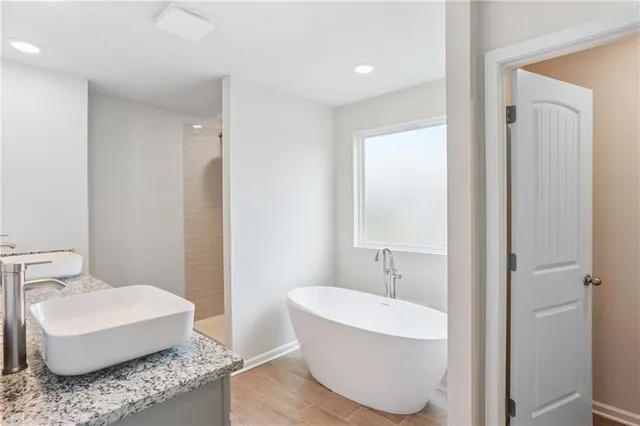 a bathroom with a tub and a sink