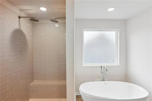 a bathroom with a sink a shower and a mirror