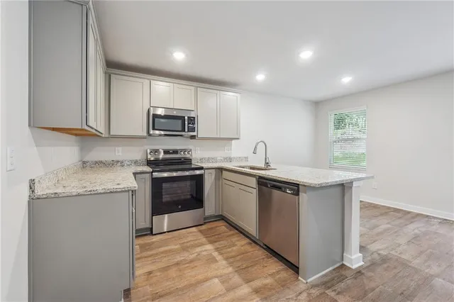 a kitchen with granite countertop a stove top oven and cabinets
