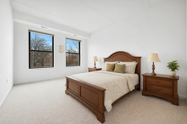 a bedroom with a bed lamp and a window