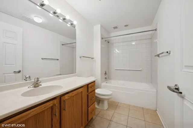 a bathroom with a sink a toilet a mirror and shower