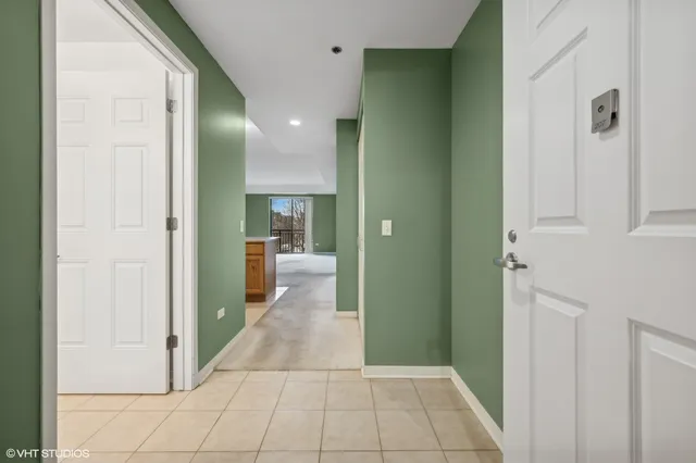 a view of a hallway with a livingroom and a bathroom