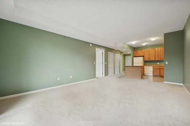 a view of an empty room with a kitchen