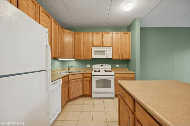 a kitchen with a stove a sink and a refrigerator