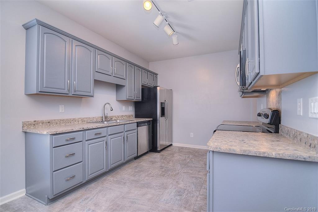 13219 Meadowmere Road Huntersville, NC 28078 - Photo 12 of 28 a kitchen with a sink stove and cabinets