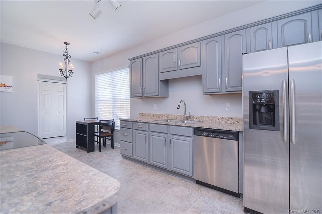 13219 Meadowmere Road Huntersville, NC 28078 - Photo 13 of 28 a kitchen with granite countertop a sink cabinets and stainless steel appliances