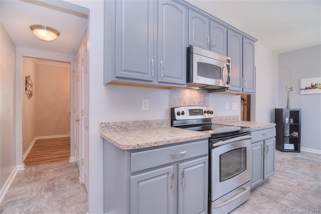 13219 Meadowmere Road Huntersville, NC 28078 - Photo 14 of 28 a kitchen with stainless steel appliances granite countertop a sink stove and microwave