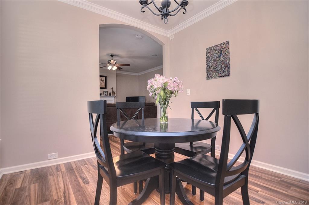 13219 Meadowmere Road Huntersville, NC 28078 - Photo 16 of 28 a dining room with furniture and wooden floor