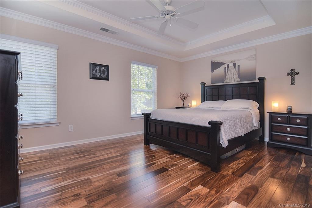 13219 Meadowmere Road Huntersville, NC 28078 - Photo 18 of 28 a bedroom with a bed wooden floor and window