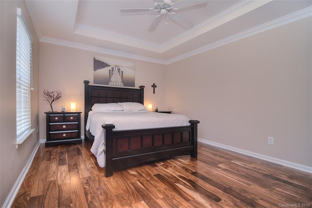 13219 Meadowmere Road Huntersville, NC 28078 - Photo 19 of 28 a bedroom with a bed and wooden floor