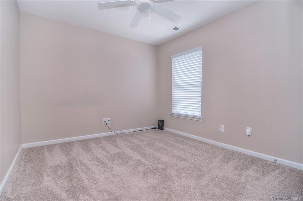 13219 Meadowmere Road Huntersville, NC 28078 - Photo 24 of 28 an empty room with a window and a ceiling fan