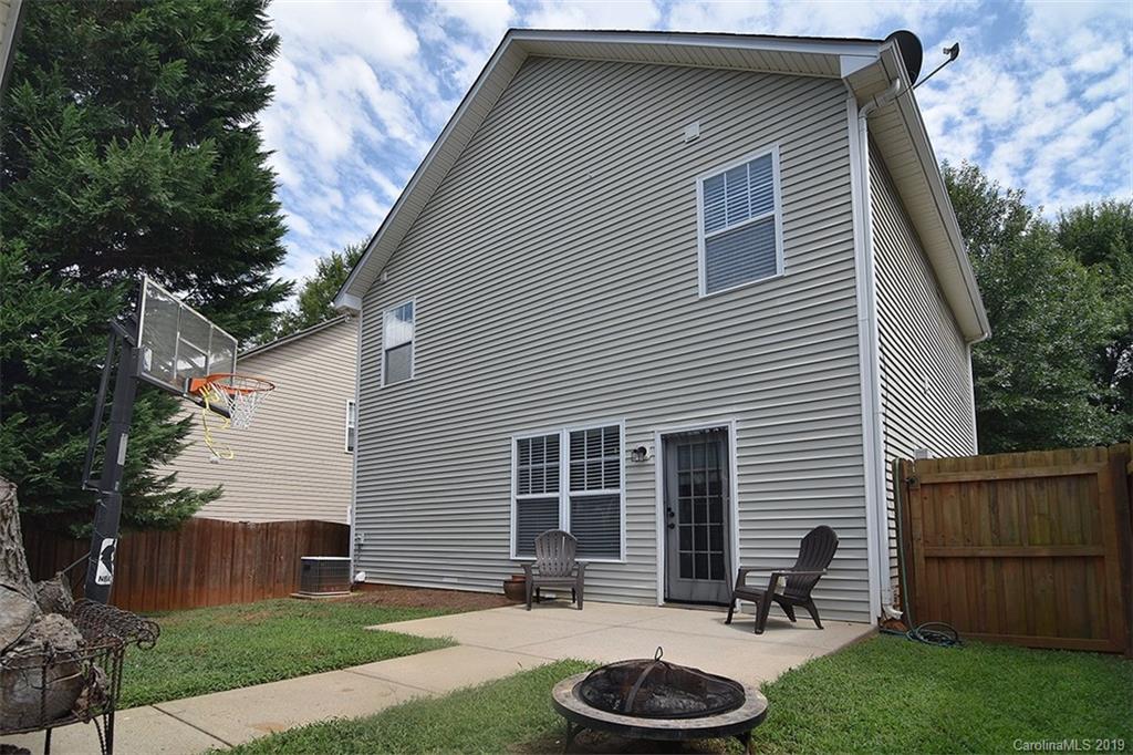13219 Meadowmere Road Huntersville, NC 28078 - Photo 25 of 28 a backyard of a house with wooden fence and a fire pit