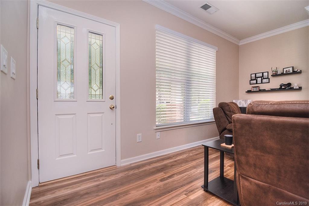 13219 Meadowmere Road Huntersville, NC 28078 - Photo 4 of 28 a view of a livingroom with a window and wooden floor