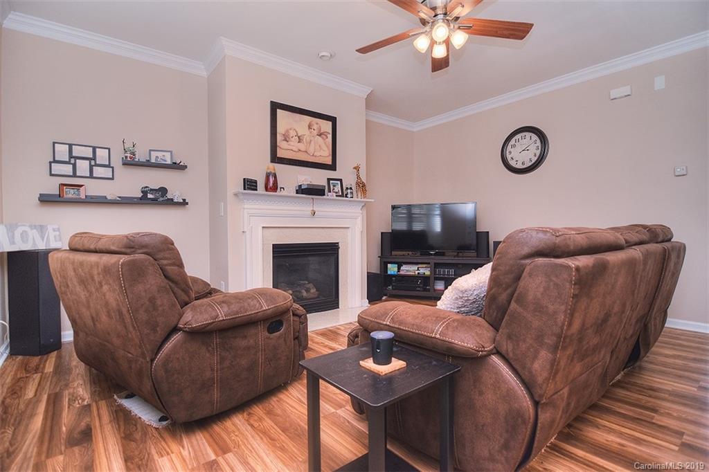 13219 Meadowmere Road Huntersville, NC 28078 - Photo 5 of 28 a living room with furniture a fireplace and a flat screen tv