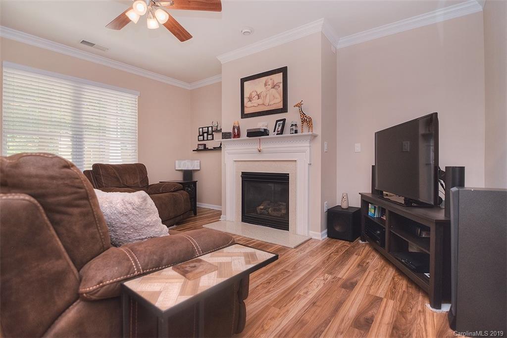 13219 Meadowmere Road Huntersville, NC 28078 - Photo 6 of 28 a living room with furniture a fireplace and a flat screen tv